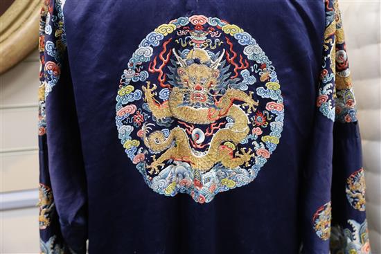 A Chinese noblewomans embroidered silk midnight blue surcoat (longgua), late 19th century, 138cm long, minor alterations to sleeves an